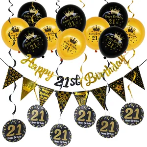 Detail of black and gold 21st birthday party decorations with balloons and hanging swirls