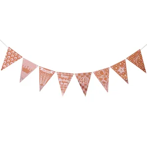 Detail of rose gold 40th birthday bunting banner with crown and cake party icons
