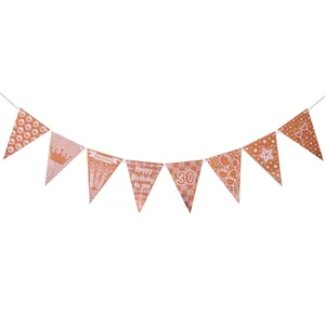 Detail of rose gold 30th birthday pennant banner with metallic finish on white background