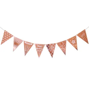 Detail of rose gold 21st birthday bunting banner with metallic crown and party icons