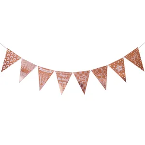 Close-up of rose gold triangle bunting banner with Happy 13th Birthday motifs