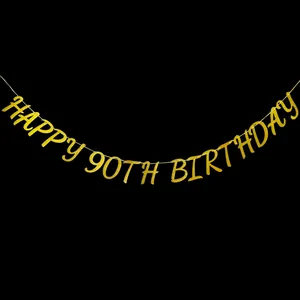 Close-up of gold glitter Happy 90th Birthday banner with shimmering texture on black background