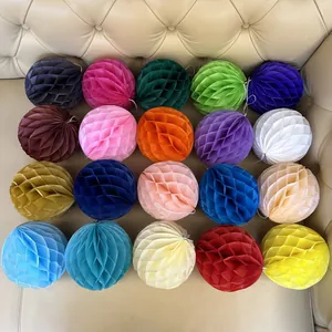 Detail of 20 multicolored paper honeycomb balls arranged in a grid for party decorations