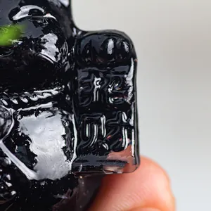 Polished black resin cat ornament featuring embossed golden lucky fortune characters