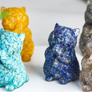Close-up of resin lucky cat figurine filled with blue lapis lazuli and natural crystals