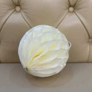 Close-up of cream honeycomb paper lantern with hanging loop for elegant party decoration