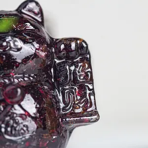 Macro detail of purple resin lucky cat figurine with natural crystal stone texture