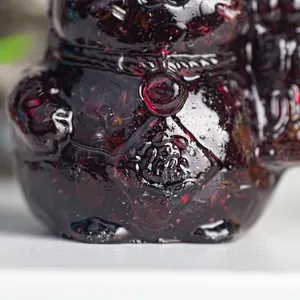 Macro shot of a translucent deep red resin cat ornament with Fu character engraving