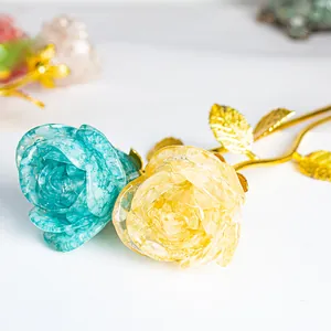 Detail of handcrafted blue and yellow crystal rose ornaments with golden metal stems