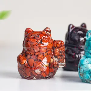 Macro detail of a resin fortune cat statue embedded with red natural crystal stones