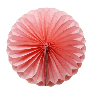 Pink paper honeycomb fan centerpiece with delicate radial fold design and texture