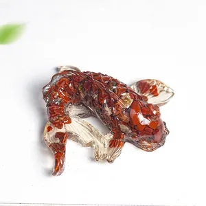 Top view of koi fish statue made of clear resin and red crystal stone fragments