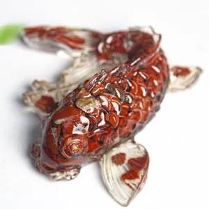 Macro view of koi fish figurine with red crystal stones embedded in clear resin