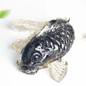 Detailed view of a handcrafted black resin koi fish statue with clear crystal fins