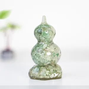 Detailed view of handmade crystal gourd ornament with natural green stone resin infill