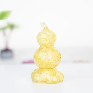 Close-up of a resin gourd ornament filled with yellow natural crystal stones