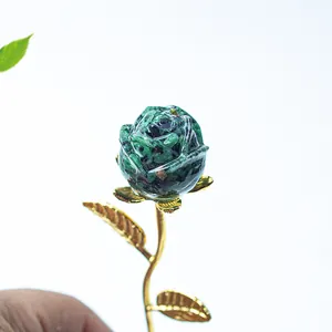 Detail of green crystal resin rose petals with golden metallic stem and leaf texture
