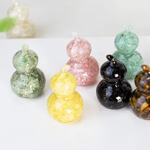 Gourd-shaped resin ornaments filled with colorful natural crystal stones on white surface