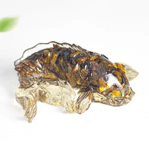 Detailed close-up of handmade resin fish koi statue with natural tiger eye stone inlay