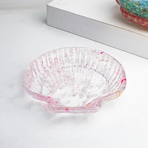 Detailed close-up of shell-shaped resin tray with pink crystal chips and textured finish