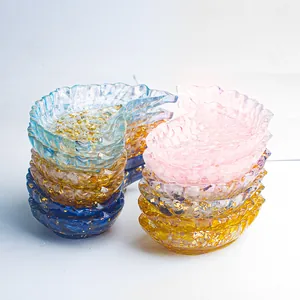 Leaf shaped resin storage tray with gold foil flakes in pink blue and amber colors