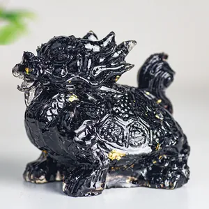 Macro detail of black crystal resin dragon turtle statue with embedded gold foil flakes