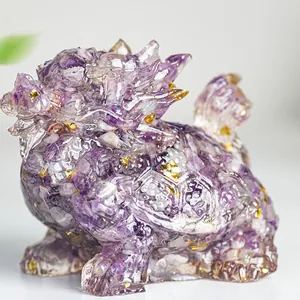 Close-up of crystal resin dragon turtle with purple stones and gold foil flakes