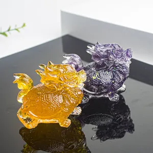 Macro view of crystal resin dragon turtle figurines in amber and violet colors