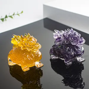 Detailed view of crystal dragon turtle resin figurines in amber and purple with glitter