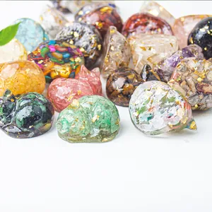Detail of sleeping cat figurines with natural crystal chips and gold foil in resin