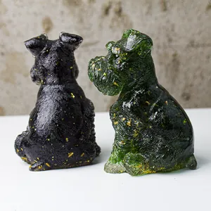 Detail of Schnauzer dog figurines in obsidian and gold foil resin with textured fur detail