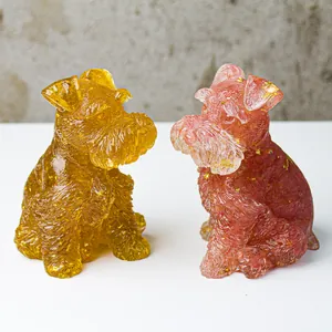 Detailed view of schnauzer dog statues in amber yellow and rose pink crystal resin
