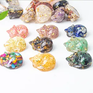 Macro shot of sleeping cat resin statues with natural crystals and gold foil inlay