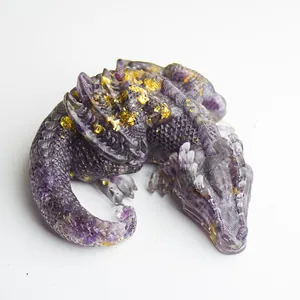 Detail of purple crystal resin dragon figurine with gold foil flakes on wings