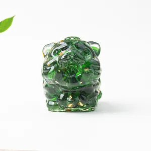 Detail of green crystal tiger figurine with gold foil flakes and resin texture