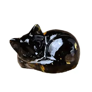 Sleeping cat statue crafted from natural black crystal resin with gold foil fragments