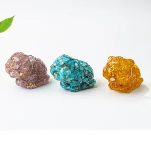 Three crystal tiger figurines in pink, turquoise and amber resin with gold foil accents