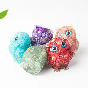 Detailed view of colorful resin owl figurines with natural crystal stones and gold foil flakes