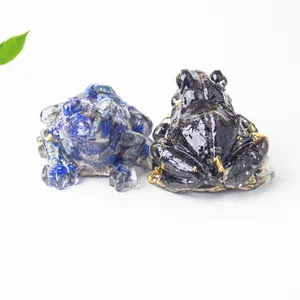Close-up of blue lapis and black gold obsidian frog figurines for desk decor