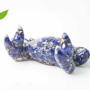 Macro shot of blue crystal resin cat figurine with gold foil flakes and stone texture