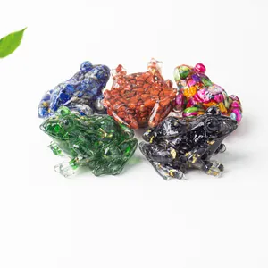 Detailed shot of resin frog figurines filled with colorful crystals and gold leaf flakes