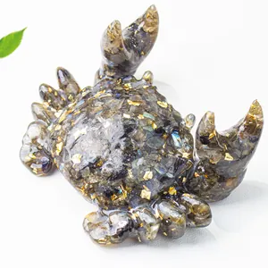 Macro detail of crab resin craft filled with labradorite stones and gold flakes