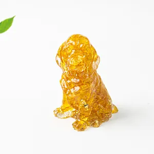 Macro view of a golden amber resin dog figurine with a polished translucent finish