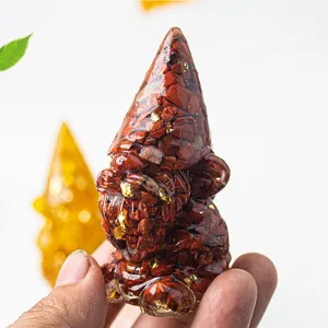 Macro detail of gnome statue made of natural red crystal stones and resin for home decor