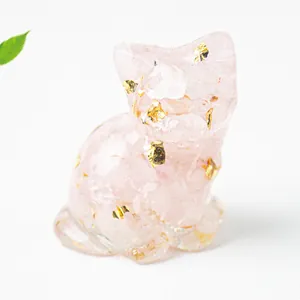Macro view of pink crystal resin cat statue with gold foil details and smooth finish