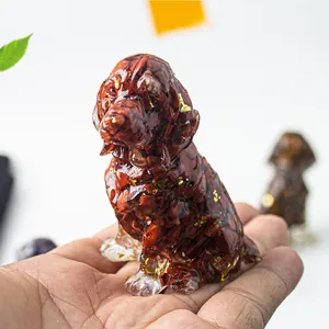 Detailed view of a handmade resin dog statue filled with red crystal and gold foil accents