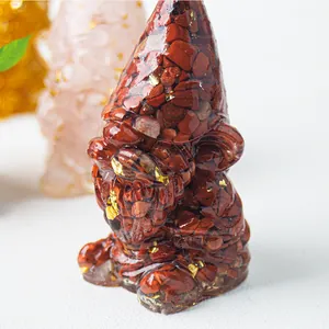 Handcrafted gnome statue with red jasper crystal, gold foil, and clear resin for home decor