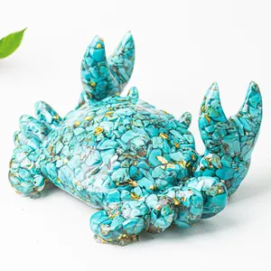 Macro shot of crab statue with turquoise chips and gold foil in clear resin