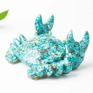 Macro detail of crab figurine with turquoise crystal stone and gold foil flakes