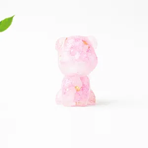 Close-up of a pink resin Schnauzer figurine with embedded crystals and gold flakes decoration